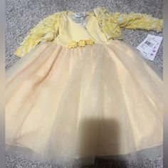 Yellow New Baby Girl Dress. Size 12 Months Long Sleeve Tutu Dress For Spring Dress-up, Long Sleeve Tutu Dress For Dress-up In Spring, Cute Spring Princess Dress For Play, Spring Princess Playtime Dresses, Spring Long Sleeve Dresses For Playtime, Long Sleeve Dresses For Playtime In Spring, Long Sleeve Dresses For Spring Playtime, Fitted Yellow Princess Dress For Spring, Long Sleeve Ruffled Tutu Dress For Baptism