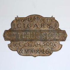 an old metal sign that says ice cream soda and imperials on it's side