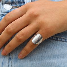 This simple and elegant ring is made by hand using high quality sterling silver materials. It is tarnish resistant and hypoallergenic so you can wear it all day, to the beach, gym etc. without worry of discoloration or irritation to your finger! The large circle center is made from a solid piece of high quality sterling silver sheet metal that has been curved to fit your finger easily and hammered to give it a beautiful shine and texture. The band is thick and strong enough to hold everything in place, but small enough to allow the circle to appear to be floating on your finger. Perfect everyday ring! Also available in 14k gold filled. All jewelry is handmade and I guarantee the workmanship and quality of all my products for one year. I use high quality stones and sterling silver or gold f Modern Sterling Silver Hammered Rings, Minimalist Hammered Signet Ring As Gift, Modern Hypoallergenic Sterling Silver Rings, Silver Hammered Signet Ring As Gift, Classic Sterling Silver Hammered Ring, Minimalist Silver Engraved Ring With Hammered Detail, Minimalist Silver Hammered Engraved Ring, Minimalist Hammered Silver Engraved Ring, Adjustable Sterling Silver Stackable Signet Ring