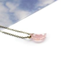 Introducing our enchanting Rose Quartz Moon Necklace, a celestial masterpiece that combines the captivating allure of the moon with the gentle, loving energy of Rose Quartz. Crafted with meticulous attention to detail, this exquisite necklace features a delicate rose quartz crescent moon pendant, suspended gracefully from a dainty chain. The moon's slender curves perfectly complement the soft, soothing hues of the Rose Quartz gemstone nestled at its center. Rose Quartz, known as the stone of unc Elegant Round Crystal Necklace With Moon Charm, Feminine Rose Gold Rose Quartz Necklaces, Elegant Crystal Pendant Necklace With Moon Charm, Elegant Handmade Half Moon Necklace, Rose Quartz Pendant Necklace In Rose Gold, Elegant Rose Quartz Round Crystal Necklaces, Elegant Adjustable Rose Quartz Crystal Necklace, Elegant Rose Quartz Round Crystal Necklace, Rose Gold Pendant Necklace With Rose Quartz