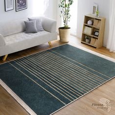 a living room with a white couch and green rug on top of the wooden floor