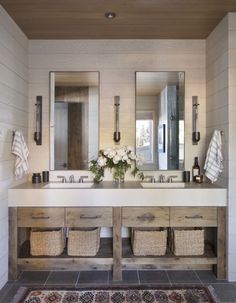 a large bathroom with two sinks and mirrors