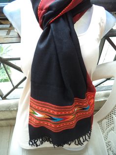 This is a lovely, elegant black coloured stole with a coloured border made in the hilly regions of Himachal, India. The Himachal region falls within the Himalayas and thus experiences colder weather than then the rest of India.  This is made from sheep wool and woven using a handloom by the Artisans in Himachal, India.  This is a super soft scarf that will be an excellent gift for the man or woman in your life! Works well as a gift for dad, mom or even grandma. This is a neutral black stole that Traditional Winter Shawl For Gift, Traditional Black Pashmina Shawl For Winter, Traditional Black Dupatta With Weaving Work, Traditional Pashmina Scarves With Weaving Work, Traditional Black Handloom Shawl, Traditional Black Dupatta With Woven Motifs, Bohemian Black Handmade Scarves, Bohemian Black Handmade Scarf, Bohemian Black Shawl With Woven Motifs