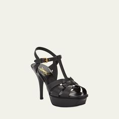 Saint Laurent leather sandal. Approx. 3" covered stiletto heel; 1.2" platform; 1.8" equiv. Tapered straps band open toe. T-strap vamp. Adjustable ankle strap. Leather lining and sole. Made in Italy Luxury T-strap Sandals With Open Heel, Evening T-strap Sandals With 4-inch Heel And Open Toe, Evening T-strap Sandals With 4-inch Heel, Evening Open Toe T-strap Sandals With 4-inch Heel, Evening T-strap Open Toe Sandals With Padded Heel, Designer Leather T-strap Sandals For Evening, Classic High Heel Sandals With Reinforced Heel, Luxury Leather T-strap Sandals For Party, Luxury T-strap Sandals With Heel Strap