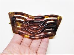 "A fabulous, exceptionally rare, antique Edwardian era hair barrette that is entirely made of celluloid plastic, including the c-clasp closure. This amazing barrette is quite large and features a lovely, intricate, curving openwork Art Deco design. The color is a lovely glowing brown color with light  tortoiseshell pattern. It's in amazing condition, still strong and ready to wear, after a century of loving use. A true collectors piece and a wonderful gift idea for antique hair accessory lovers. Gift boxed and ready for gifting in an elegant gray jewelry box tied with white satin ribbon. -Age: Early 1900's (1900 to 1920) -Material(s): Celluloid plastic -Size: 4-1/2\" long by 2\" wide -Brand / Hallmarks: Unsigned -Condition: In excellent usable condition. No noticeable flaws. More Vintage H Edwardian Hair, Flapper Hair, Edwardian Hairstyles, Gray Jewelry, Edwardian Era, Art Deco Design, Hair Barrettes, Tortoise Shell, Vintage Art Deco