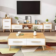 a living room scene with focus on the coffee table and entertainment center, which is decorated in white and natural wood