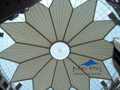 an overhead view of the ceiling in a building with glass roofing and skylights