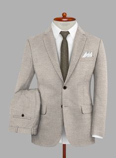 Emulate every experience with graceful precision with the Loro Piana Elettra Wool Silk Linen Suit, a testament to understated prestige. This versatile ensemble features a blend of wool, silk, and linen in a classic beige hue with a solid pattern. The luxurious fabric composition ensures a breathable feel with a subtle sheen, making it ideal for warmer seasons and formal affairs alike. Whether commanding upscale gatherings or attending a summer soirée, this suit exudes timeless style and impeccable taste.   A marriage of elegance and comfort, Loro Piana fabrics are made using the highest quality raw materials in the world, in their purest form or blended together. A sophisticated response to the dictates of contemporary elegance, these fabrics lend themselves to a wide range of styles to me Timeless Beige Linen Suit, Elegant Linen Suits With Notch Lapel, Luxury Linen Suits, Fitted Beige Linen Suit, Elegant Linen Blazer For Business, Elegant Linen Blazer For Tailoring, Tailored Beige Linen Suit, Beige Linen Suit For Wedding, Timeless Linen Formal Suits