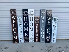 three wooden signs that say welcome, welcome and welcome on the side of a building