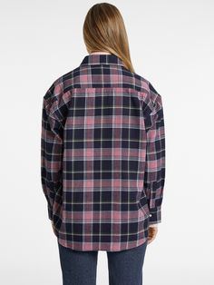 An oversized button-up shirt with dual front pockets features an elongated silhouette with a baggier, boyfriend look. Trendy Fall Shirt For Daywear, Oversized Shirttail Hem Shirt For Fall, Oversized Fall Shirt With Shirttail Hem, Classic Oversized Button-up Flannel Shirt, Spring Casual Workwear Flannel Shirt, Spring Casual Flannel Workwear Shirt, Spring Casual Flannel Work Shirt, Oversized Classic Fall Flannel Shirt, Casual Collared Flannel Shirt For Work