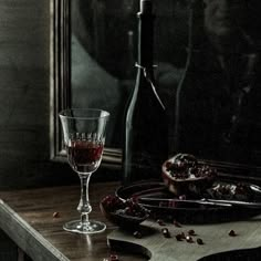 a bottle of wine sitting on top of a wooden table