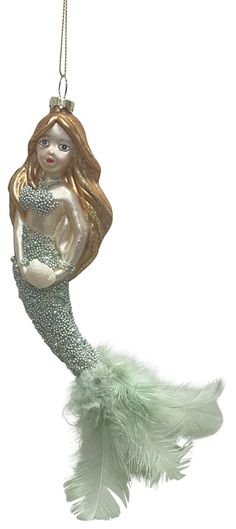 a christmas ornament with a mermaid holding a baby's breath on it