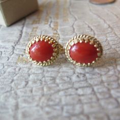 Salmon Red, Sometime Referred to as Sardinian (in color) Gemstone Coral Cab aka Cabochon set in 14k Yellow Textured Gold Pierced Stud Elegant Earrings, Stamped 14k. Everyday Gem Coral & Fine Gold Jewelry, Italian Coral likely (meaning not Asian), good overall condition, the coral has natural markings within the cabochon stones, so they are not flat solid orange, that is how we know they are genuine coral. Perfect size studs with just the right flash of color.  Remember the Victorians put coral on everyone as it was used as protective power against the evil eye and such... 13 MM or 1/2 IN x 11.3 MM or 7/16 IN Stamped 14k  Oval Shape  2.7 grams total weight Studs  They didn't have backs, so I added the ones that fit best, I think they are gold fill Red or Salmon Color  I believe they are Ita Formal Red Jewelry With Matching Earrings, Classic Red Jewelry With Matching Earrings, Red Classic Jewelry With Matching Earrings, Elegant Red Earrings With Polished Finish, Classic Red Round Jewelry, Traditional 14k Gold Jewelry For Formal Occasions, Red Cabochon Jewelry For Formal Occasions, Red Polished Earrings For Gift, Fine Jewelry In 14k Gold And Red Color