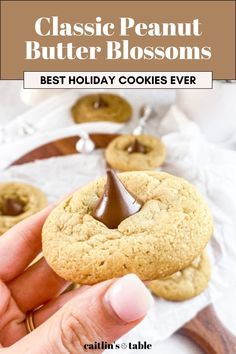 a close up of a person holding a cookie with chocolate on it and the words, classic peanut butter blossoms best holiday cookies ever