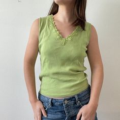 "vintage sequin green texture tank 100% cotton, stretchy lightweight material! pretty shade of green. great for summer, small mark near neckline as shown in photo measurements (taken flat): 22\" length 17.5\" pit to pit free shipping! We are a sustainable, curated and custom shop called AKIND - bringing new trends to one of a kind thrifted and vintage! We treat each order with care and are appreciative for each one. Please don't hesitate to contact us with questions about sizing or other; we respond quickly! We currently don't accept returns/exchanges due to the difficulty, delayed times, and expensiveness of shipping during a pandemic. Thank you for understanding!" Y2k V-neck Tank Top For Spring, Green Cotton V-neck Tank Top, Green V-neck Y2k Tops, Green Y2k Style Summer Top, Green Summer Y2k Tops, Green Y2k Summer Tops, Casual Green Stretch Tank Top, Green Y2k Tank Top For Spring, Sleeveless Light Green Summer Tops