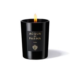 a candle that is lit up with the words acqua di parmaa on it