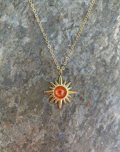 This necklace is handmade with a 19mm by 21mm 14k gold-plated stainless steel pendant and a 6mm genuine sunstone cabochon. The chain is 14k gold-filled and will not tarnish.  This necklace is hypoallergenic. (Cadium free, lead free, and nickel safe) Sunstone is an empowering crystal that promotes optimism and confidence. Please note that each stone is unique and varies in color.  Each necklace comes in a ribbon-wrapped box, ready to be gifted. If you would like to leave a note for the recipient, Handmade Gold Charm Necklaces With Star Shape, Gold Star Charm Necklace Handmade, Handmade Gold Star Charm Necklaces, Handmade Gold Star Charm Necklace, Gold Starburst Necklace For Gift, Adjustable Gold Cabochon Necklace, Handmade Gold Star Necklace, Handmade Star-shaped Gold Necklace, Gold Spiritual Necklace With Cabochon