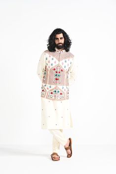 Ivory floral hand embroidered nehru jacket with intricate details on Linen Satin. Paired with Ivory slim fit Pant Pajama. Color of the actual garment may vary due to lighting conditions during the shoot.

Size Chart For Men





	
	
					Men's Size Chart
		

		
		
						
				Size Chart For Men
				Custom Size Measurement Guide
			
			
				
				
				Custom Size Measurement Guide
1. Take your measurements at ease…don’t hold your breath!
2. Be a little generous with the measurements. It’s always ea Cotton Nehru Jacket With Floral Embroidery, Chanderi Nehru Jacket With Floral Embroidery, Floral Embroidered Chanderi Nehru Jacket, Bollywood Cotton Bandhgala With Floral Embroidery, White Long Sleeve Chanderi Bandhgala, White Bandhgala With Floral Embroidery For Festive Occasions, White Floral Embroidered Bandhgala For Festive Occasions, Transitional Cream Chanderi Sherwani, Festive White Bandhgala With Floral Embroidery