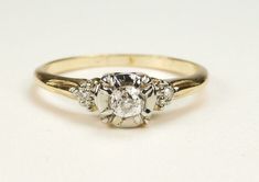 three stone diamond ring on white background