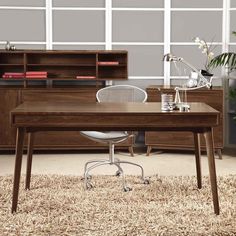 a wooden desk sitting on top of a carpeted floor next to a book shelf