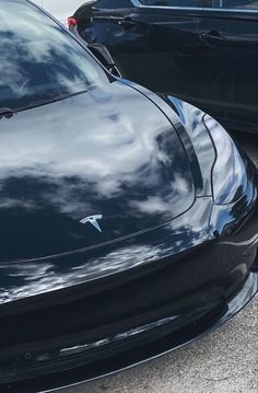 the front end of a black sports car