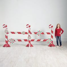 a girl standing in front of candy canes