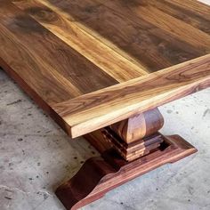 a wooden table sitting on top of a cement floor