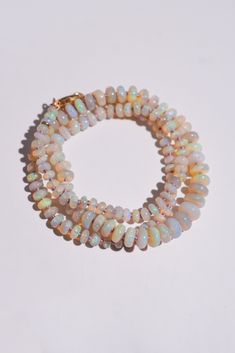 Australian Opal Knotted Candy Bead Necklace on white background Single Strand Pink Opal Necklace With Round Beads, Polished Round Bead Opal Necklaces, Polished Round Opal Bead Necklaces, Opal Rondelle Bead Necklace, Handmade Opal Bead Necklaces, Opal Gemstone Beaded Rondelle Necklace, Handmade Opal Necklaces With Round Beads, Opal Rondelle Necklace With Gemstone Beads, Opal Necklaces With Polished Round Beads