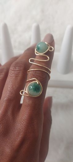 This beautiful wire wrapped ring is adorned with beautiful green jade beads. The ring sits comfortable on the find and can be easily adjusted to be tighter or looser on the finger. The wire used is a beautiful gold tarnish resistant craft wire. Ring Sizing: If you need help figuring out your ring size - contact us as we can provide you with a printable ring sizing packet with diy instructions. Care Instructions: Avoid leaving ring in moist or damp places. Remove during hand washing. Do not overs Wire Rings Ideas, Diy Wire Wrapped Rings, Wired Jewelry, Wire Wrapping Diy, Wire Wrapped Ring, Wire Ring, Diy Rings, Wire Rings, Wire Wrapped Rings