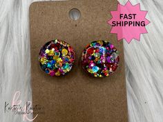 Shenanigans is a super popular mixture of bright color circle dots. These stud earrings are PERFECT for ANY outfit!! We are NOW OFFERING TWO STUD SIZES: Small - .5" Large .75" Earrings are made with high quality resin and glitter and sealed with high quality UV Resin to give a smooth glasslike finish.  Studs are post backs. Gold Hardware. All earring hardware is Nickel-Free **Shenanigan studs that show available are IN STOCK and will ship out SAME DAY or NEXT DAY depending on time of day ordering.** Diy Resin Stud Earrings, Colorful Stud Earrings, Resin Stud Earrings, Diy Resin Projects, Circle Stud Earrings, Earrings Circle, Color Circle, Earrings Colorful, Epoxy Resin Crafts