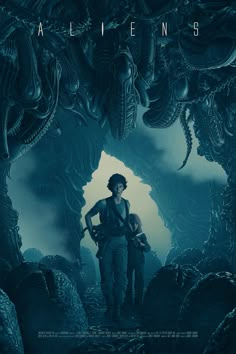 aliens movie poster with two people standing in front of an alien like creature and another man