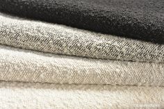 several different types of towels stacked on top of each other in various colors and patterns