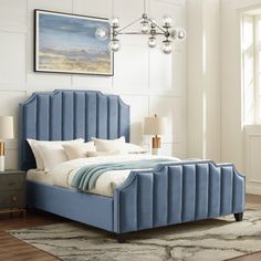 a blue bed with white sheets and pillows