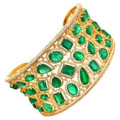 A stunning statement cuff handmade in 18K gold. It is set in 45.46 carats emerald and 10.41 carats of sparkling diamonds. FOLLOW MEGHNA JEWELS storefront to view the latest collection & exclusive pieces. Meghna Jewels is proudly rated as a Top Seller on 1stDibs with 5 star customer reviews. All items manufactured by us are handmade and can be customized or redesigned. Composition Size-48X58 MM Total Weight-64.84 Gold Weight(Gms)-45.35 Diamond Wt(Cts)-10.41 Emerald Wt(Cts)-45.46 Luxury Green Cuff Bracelet For Formal Occasions, Luxury Green Bangle, Luxury Green Gemstone Bangle, Elegant Green Cuff Bracelet For Formal Occasions, Green Bangle For Formal Occasions, Fine Jewelry Style, Luxury Green Cuff Bracelet As Gift, Formal Green Emerald Bangle, Luxury Emerald Bangle Jewelry, Luxury Green Bangle For Anniversary