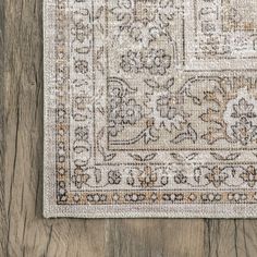 an area rug on top of a wooden floor with a wood floor in the background