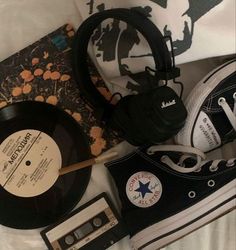 an old pair of sneakers, headphones and record player