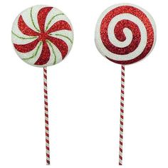 two red and white lollipops on top of each other with glittery tops