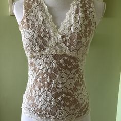 Beautiful Nude Illusion Cabi Lace Tank. Never Worn - No Stains Or Flaws! Sleeveless Sheer Lace Tops, Sleeveless Stretch Lace Top, Sheer Sleeveless Lace Top For Summer, Beige Fitted Lace Tank Top, Elegant Sheer Sleeveless Tank Top, Fitted Sleeveless Lace Blouse, Fitted Sleeveless Lace Top, Sleeveless Lace Top Intimate For Summer, Sheer Stretch Sleeveless Camisole