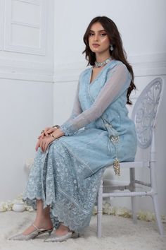 Using a contrast of refreshing powder blue, this net angrakha is made with delicate lace work high low double tassels made of crystal beads, pearls and contrasting thread. Continued with fully Embroidered border offset with lace detailed straight pants and delicately thread work on dupatta which has rich thread work tassels on four sides to make them look more effortless. Shirt Fabric: Embroidered khadi Net Shirt Length: 48” (customizable, mention in order notes) pants Fabric: Raw silk Dupatta F Designer Light Blue Dress With Chikankari Embroidery, Designer Light Blue Chikankari Embroidery Dress, Traditional Light Blue Sets With Sheer Dupatta, Light Blue Chikankari Embroidered Sharara For Wedding, Light Blue Sets With Intricate Embroidery, Elegant Light Blue Salwar Kameez With Zari Work, Light Blue Salwar Kameez With Zari Work Elegant Style, Light Blue Bollywood Set With Sheer Dupatta, Light Blue Bollywood Style Set With Sheer Dupatta