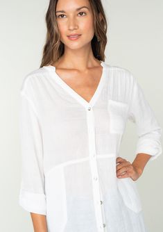 A classic lightweight button-front tunic shirt with side pockets. FINAL SALE Tunic shirt Relaxed, oversize fit Long rolled sleeve with button tab closure Banded collar V-neckline Button front Side pockets Sheer Classic bohemian shirt A must-have addition to any woman's wardrobe, this lightweight shirt adds an effortless laid back feel to any outfit. Featuring long rolled sleeves with a button tab closure, side pockets, and a long tunic length. Throw it on over your swimsuit at the beach, or wear Relaxed Beach Button-up Shirt, Relaxed Button-up Beach Shirt, Casual Tops With Button Cuffs For Layering, Oversized V-neck Blouse With Button Closure, Button-up Beach Shirt With Placket Detail, Casual Beach Tops With Button Cuffs, Bohemian Button-up Beach Tops, Fall Beach Shirt With Button Closure, Spring Beach Top With Placket