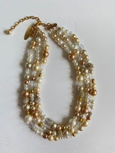 Classic and timeless Elegant Multi-strand Beige Necklace, Elegant Beige Multi-strand Necklace, Pearl White Multi-strand Beaded Necklace, Multi-strand Pearl Necklace With Pearl Charm, Elegant Multi-strand Cream Beaded Necklaces, Elegant Cream Multi-strand Beaded Necklaces, Elegant Cream Multi-strand Beaded Necklace, Vintage Multi-strand White Pearl Necklace, Cream Multi-strand Pearl Necklaces