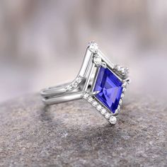 Breathtaking Kite Cut Tanzanite Ring, a mesmerizing symbol of love and commitment crafted with precision and passion. This exquisite ring is meticulously designed with a 925 sterling silver band, showcasing a unique geometric setting that adds a contemporary and elegant touch to the classic engagement ring.►At the heart of this stunning piece is a captivating kite-cut Tanzanite gemstone, renowned for its enchanting purple hue. The vivid and alluring color of Tanzanite is not only a visual feast Lights Trees, Couples Ring, Classic Engagement Ring, Traditional Engagement Rings, Couples Ring Set, The Aurora Borealis, Classic Engagement, Tanzanite Ring, Matching Wedding Bands