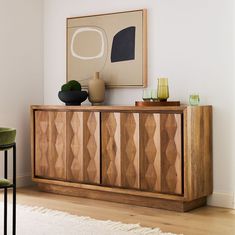 a wooden cabinet sitting in the middle of a living room