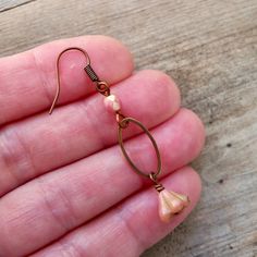 "These lightweight earrings are a wonderful compliment to you comfortable jeans and t-shirt, or maybe dress it up a bit. These are coral pink Czech glass beads. The top bead is a 4mm faceted bead. The bottom bead is a beautiful little 5x8mm, bell shaped floral bead. As you can see by the last photo, there are other colors available too. If you would like one of those options, just pick the number you want, otherwise please pick the one that says \"as shown\", during checkout. I would match the t Spring Gift Teardrop Dangle Earrings, Spring Adjustable Teardrop Earrings, Vintage Dangle Earrings For Spring, Everyday Bohemian Dangle Flower Earrings, Teardrop Earrings With Ear Wire For Spring, Spring Teardrop Earrings With Ear Wire, Hypoallergenic Dangle Earrings For Spring, Casual Dangle Earrings For Spring, Hypoallergenic Spring Dangle Earrings