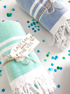 two towels wrapped in blue and white with a tag that says last sail before the veil