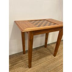 a wooden table with chess board on top