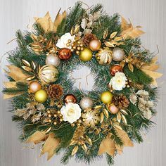 a christmas wreath with gold and white ornaments