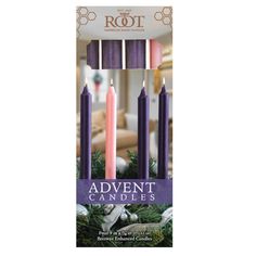 an assortment of purple candles in front of a christmas tree