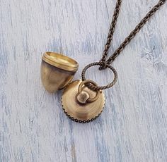 This hand burnished brass acorn measures 1" in length and 3/4" in diameter and has a lid that screws off to reveal a small container inside. The possibilities are endless as to what you can put inside. It’s a great piece to layer with other my other pieces or wear on its own. Need to secure the top permanently? A little loctite from your local hardware store can be applied to the area where you screw the capsule together and it will be permanently sealed! **Chain lengths can be customized, and I Unique Locket, Acorn Necklace, Small Container, Pendant Locket, Burnished Brass, Linking Rings, Small Containers, Hardware Store, Pet Memorial