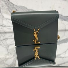 Cross Body Bag Ysl Clasp 100% Leather Width 8.8in/22.3cm Length 6in/15.2cm Depth 2in/5cm Approximate Strap Drop Length 24in/61cm Folded Curb-Chain Shoulder Strap Gold-Tone Metal Hardware Two Compartments, One Zip-Fastening Pocket, One Slip Pocket Burgundy Leather Lining Ysl Plaque Fastening Made In Italy Ysl Cassandra, Bags Ysl, Bag Ysl, Saint Laurent Bags, Yves Saint Laurent Bags, Cross Bag, Curb Chain, Gucci Dionysus, Cross Body Bag